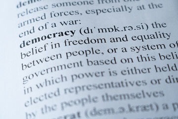 A mock up of a dictionary page with the word democracy with selective focussing