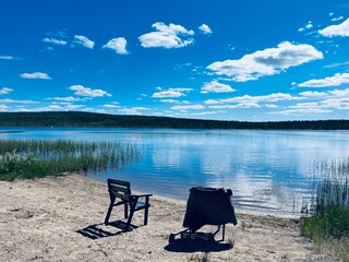 Two chairs in front of the lake, lake view, no people, very quiet and romantic