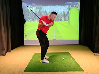 Male golfer makes swing golf club indoors concept