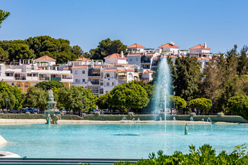 Sprinkling fountain in the park, sunny spring view from "Parque de la Batería" in Torremolinos, Málaga, Spain