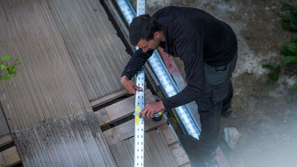 An electrical engineer from the team cut chutes that will serve as support for the electrical...
