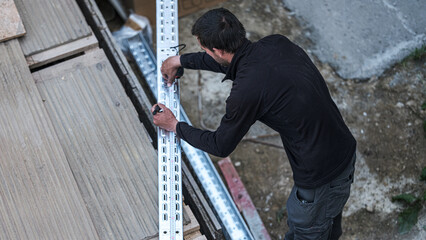 An electrical engineer from the team cut chutes that will serve as support for the electrical...