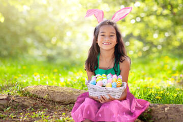 Little girl with Easter bunny. Egg hunt.