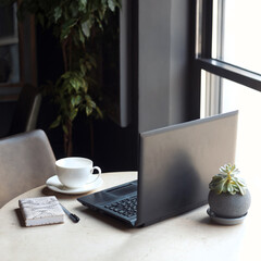 Square photo of freelancer workspace with laptop, notepad and pen, cup of hot coffee for breakfast....