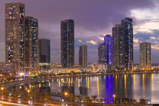 Sharjah city in uae cityscape at sunset in a cloudy day  with lake view