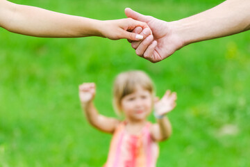 hands Happy parents and child outdoors in the park