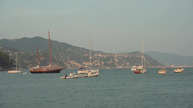 RAPALLO, LIGURIA, ITALY - AUGUST 22, 2018: Yachts in Rapallo at beautiful summer sunset, Italy. 4K, Wide shot, Handheld
