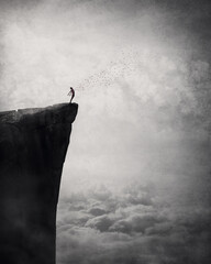 Freedom and liberty conceptual scene. Man on the edge of a cliff self liberating from fears and...