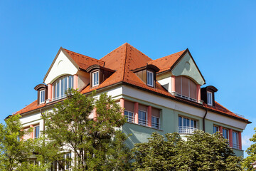 Building Exterior with Red Tiled Roof and Garden around. Eco House in Eco City of Germany. German Town.