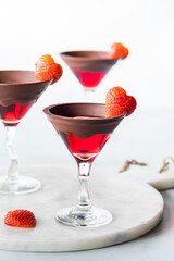 Beautiful chocolate rimmed Valentine's Day cocktails with strawberry garnish.