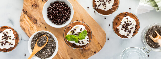 Top down narrow view of chocolate mousse chia pudding, ready for eating.