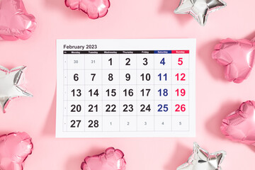Valentine's Day background. Date February 14 on calendar 2023,  heart-shaped balloon on pink...