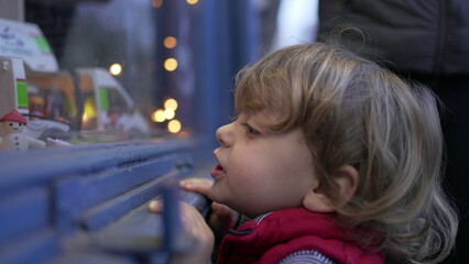 Child choosing product at grocery store window