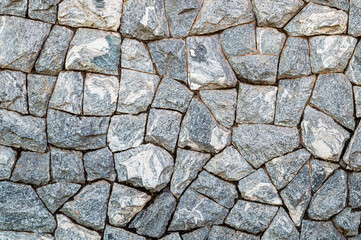 Wall of gray cracked stones. Pattern. Advertising space. Design element. Background. Horizontal.