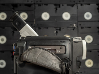 Vintage retro video camera, tape recorder, close-up object. Outdated old technology, film production, cinema equipment concept.