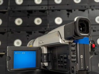 Vintage retro video camera, tape recorder, close-up object. Outdated old technology, film...