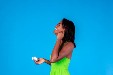 Joyful young ethnic woman wearing wireless earbuds and laughing