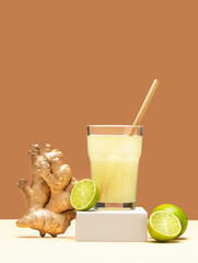 Ginger drink on white podium. Modern still life with Lime and ginger. Creative layout - refreshing...