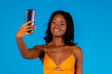 Ethnic woman taking selfie via smartphone