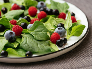 Healthy salad with fresh New Zealand spinach, blueberries, raspberries and blackcurrants