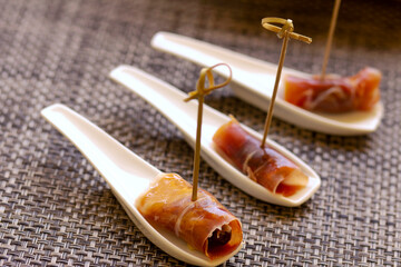 Close up of traditional Spanish Jamon Serrano ham. Three slices of Dry iberian ham, Bellota, Italian Prosciutto Crudo or Parma ham served as tapas. ..