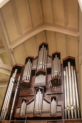 Massive Church organ instrument made of steel and timber in old traditional style, in main modern Chatolic Church In Abuja, capitol of Nigeria, Called National Ecumenical Centre - obrazy, fototapety, plakaty