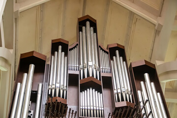 Massive Church organ instrument made of steel and timber in old traditional style, in main modern...