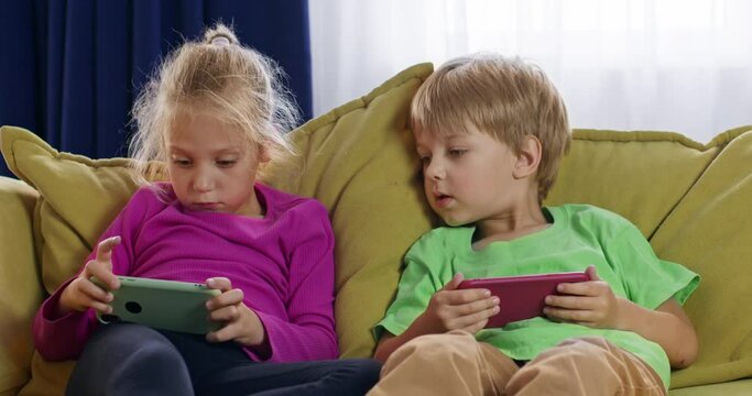 Children spend their free time with gadgets, play games on phones, children's addiction to smartphones. Decreased vision from phone screens.