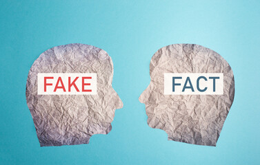 Fake or fact on a head, false and truth information, propaganda and conspiracy theory concept,...