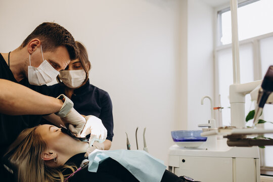 Young dentist wearing optragate for the young patient, preparing for the dental checkup. Regular visit to the orthodontist. 4k video screenshot, please use in small size