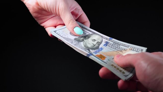 Hands counting US Dollar bill or paying in cash on black background. Payment, investment career growth receiving money, receiving a large sum