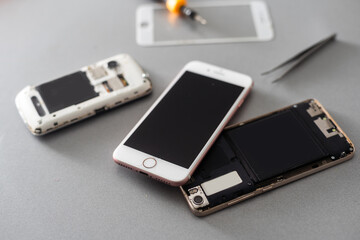The technician repairing the smartphone's motherboard in the lab with copy space. the concept of...