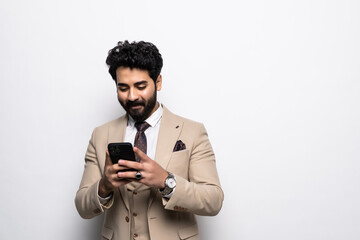 Arab young businessman ceo bank worker employee freelancer financial adviser in formalwear using smart phone cellphone for online mobile applications, calls isolated in white
