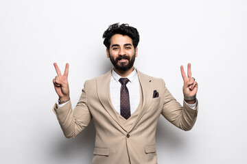 portrait of a happy Arab businessman with v-sign isolated on white background