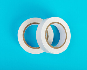 White Electrical Tape, Plastic Duct Tape Rolls, Colored Adhesive Tapes on Blue Background