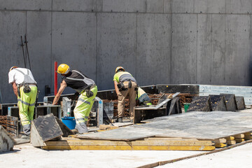 Construction workers at work on a construction site - 560256149