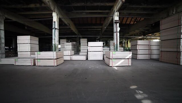 Warehouse of finished particleboard and wood building material. Lumber in the production of wood