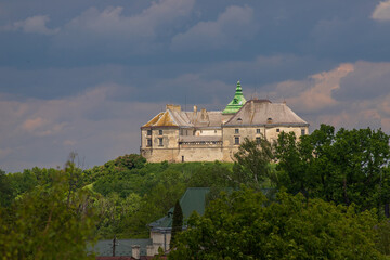 Fototapeta na wymiar Olesko Castle, oval in shape, stands on top of a small hill