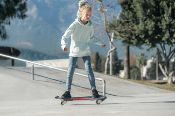 Girl riding on waveboard with two wheels, modern street skate sports of teenagers, casterboard or ripstick for balance ride.