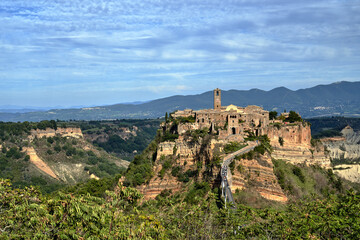 Fototapeta na wymiar the historic stone town of Bagnoregio at the top of the rock with concrete footbridge