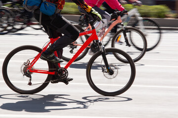 Fototapeta na wymiar cyclists race their bikes in a sunny summer city