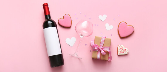 Obraz premium Composition with bottle of wine, glass, heart shaped cookies and gift on pink background. Valentines Day celebration