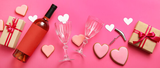 Composition with bottle of wine, glasses, heart shaped cookies and gifts for Valentines Day on pink background