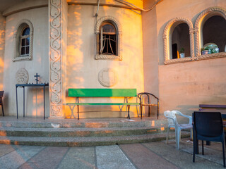 Church exterior. Church courtyard. Architecture of Georgia.   Benches next to the temple.