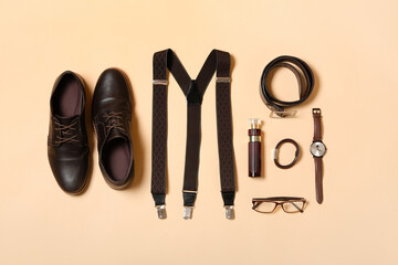 Male shoes and accessories on beige background