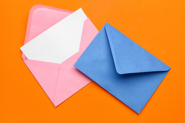 Two envelopes on color background