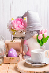 easter decorations on the table. Table decoration rabbit, carrot, painted eggs and a bouquet of flowers on a tray