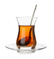 Glass of Turkish tea with spoon on white background