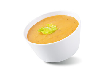 Celery carrot puree soup in a bowl on a white isolated background