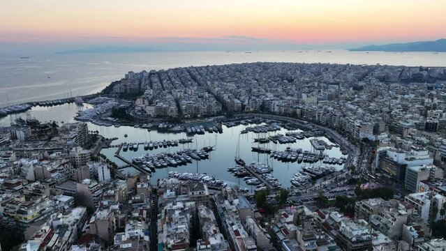 Aerial drone video of iconic round port and Marina of Zea or Passalimani at dusk with beautiful colours, Piraeus, Attica, Greece